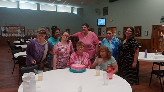 The Living Well students celebrating a birthday.